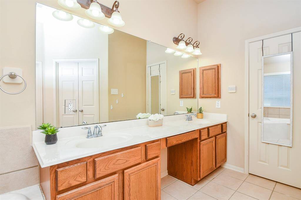Primary bathroom with dual sinks for added convenience.