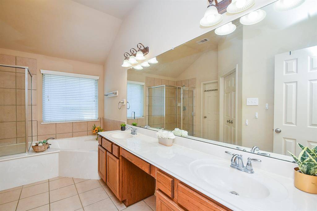 Primary bathroom features a separate shower and jetted tub.
