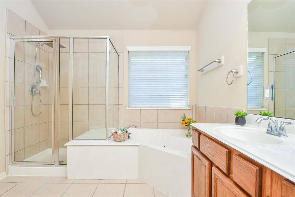 Primary bathroom features a separate shower and jetted tub.