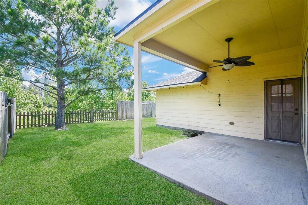 Private backyard with a covered patio, nestled among mature trees and no rear neighbors.