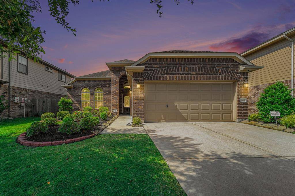 Charming brick facade with a welcoming entrance and beautifully landscaped front yard.