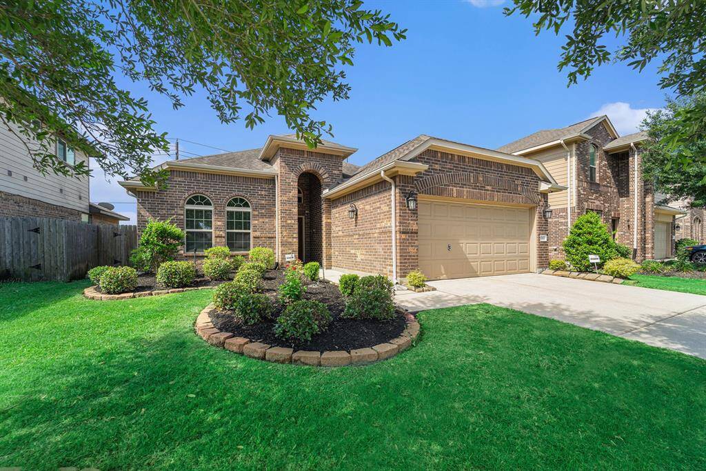 Charming brick home with manicured lawn and inviting curb appeal.