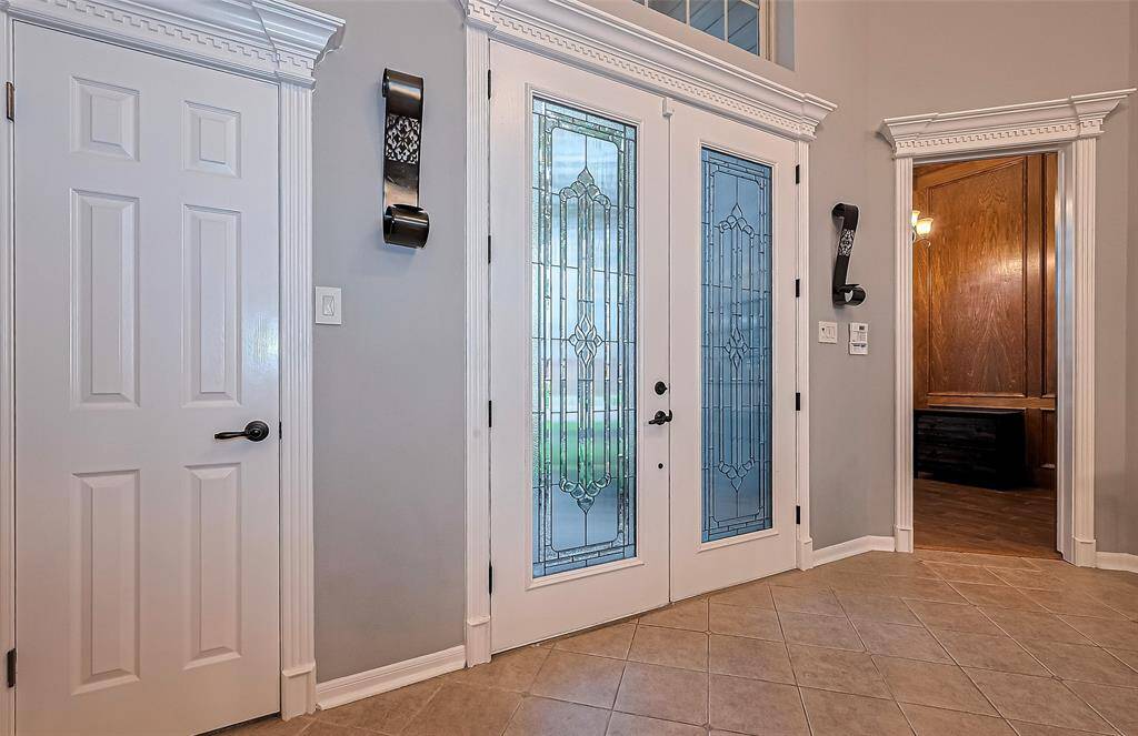As you step foot inside, you can't help but notice the intricate custom woodwork around the door casings.