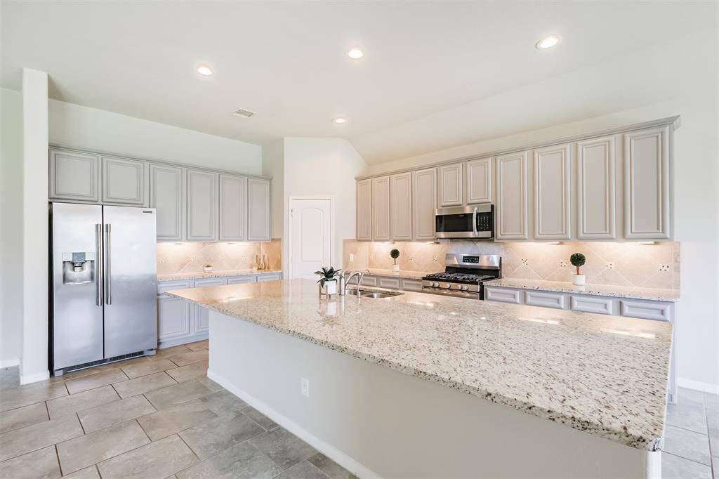 Beautiful Kitchen open to dining & Living areas w/ refrigerator, corner Pantry, Granite Counters, Plenty of Cabinet Space.