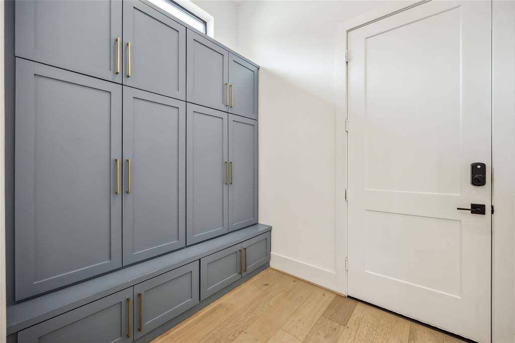 Tranquil large primary suite with a seating area, abundant natural light, and tray ceilings.