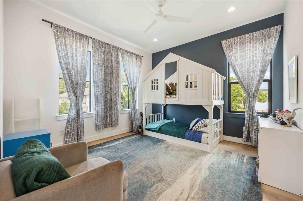 Shared Jack-and-Jill bath featuring double sinks, designer fixtures, dual custom closets and private access from each adjoining bedroom—ideal for functionality and privacy.