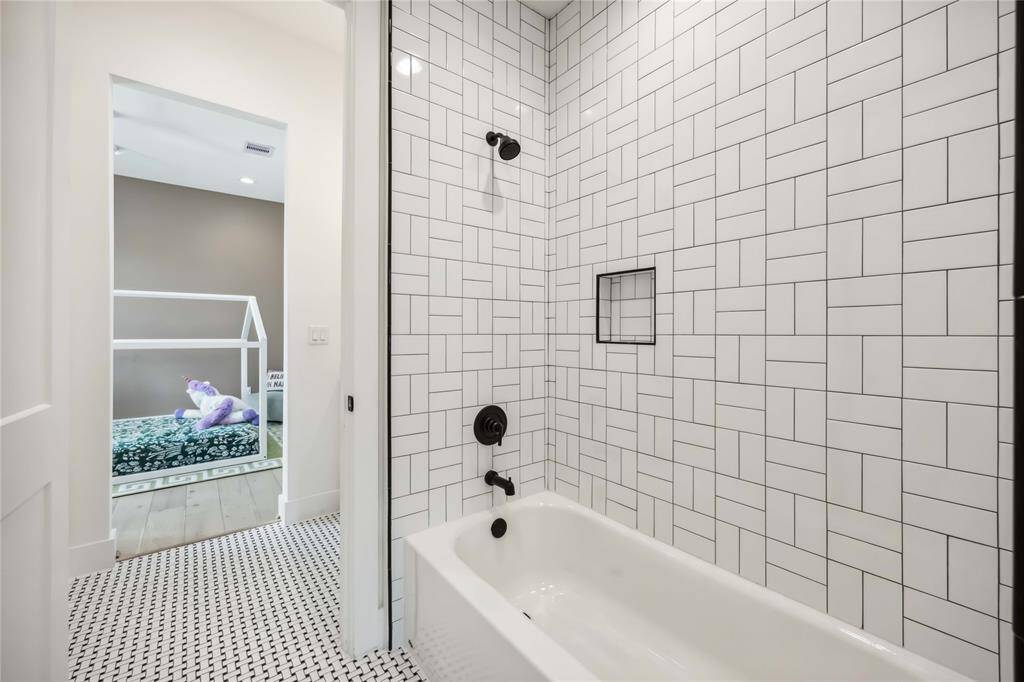 Jack and Jill shared bathroom with custom cabinetry and upscale decor