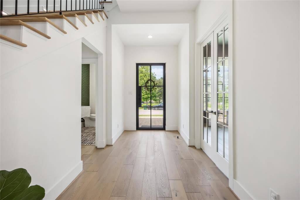 Modern foyer with immediate access to a sleek wet bar, offering a sophisticated welcome and a seamless flow into the home’s main living areas.
