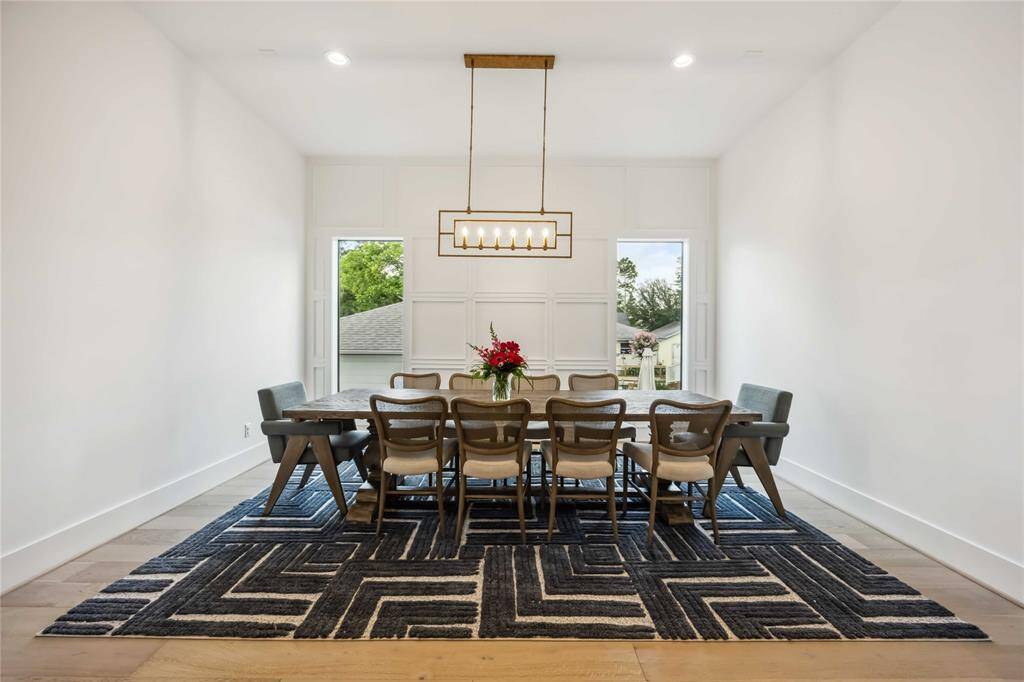 This artfully designed corridor features elevated finishes and an open sightline into the spacious family room, anchored by warm wood floors and architectural charm.