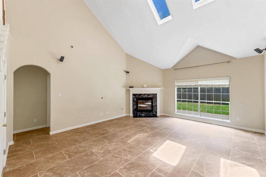 Living Room with Raised Ceiling and Skylight