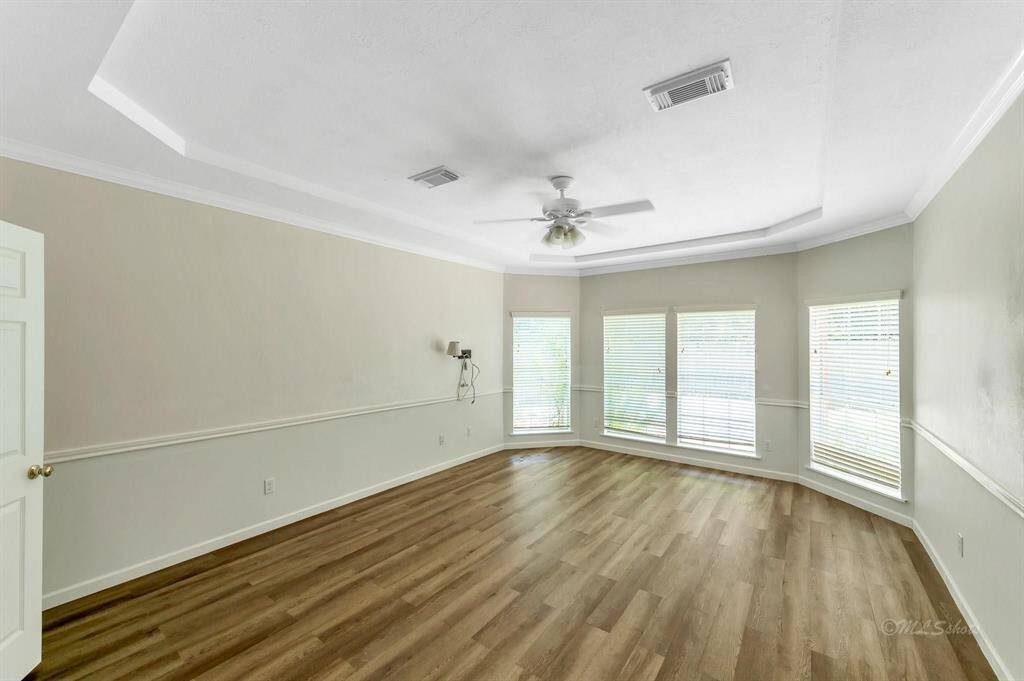 Primary Bedroom with Vaulted Ceiling and Large Windows
