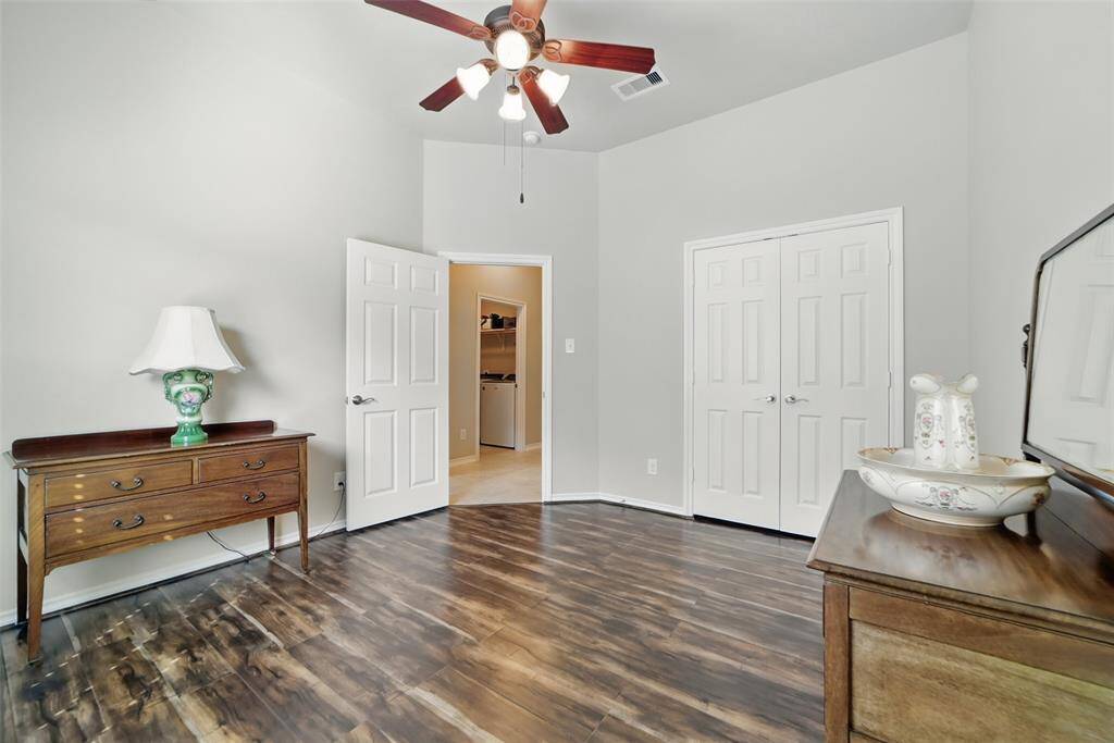 View across bedroom shows sneak peak to laundry room