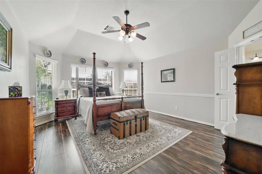 Large primary suite with wood floors