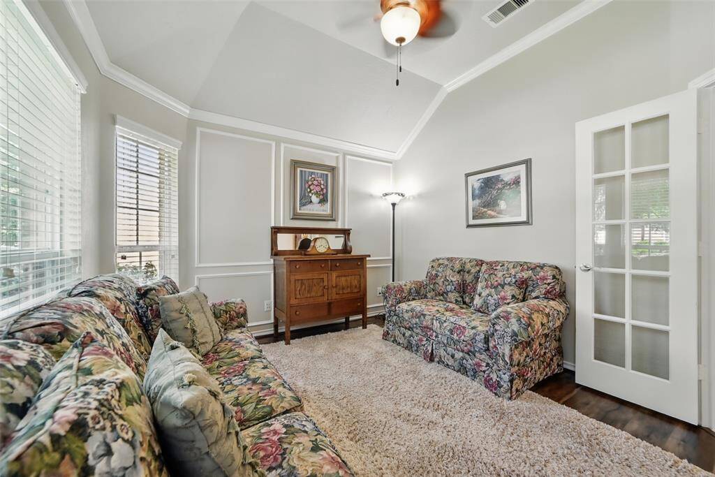 Wood floors, french doors ceiling fan in study