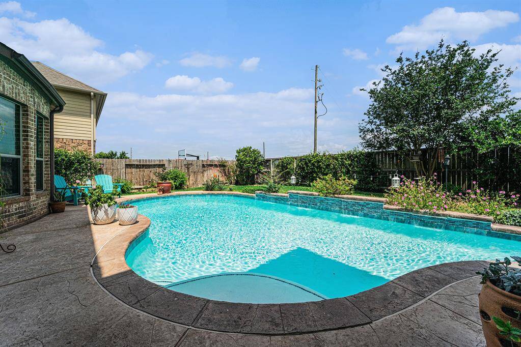This crystal clear pool with water feature is perfect for those hot Summer days.