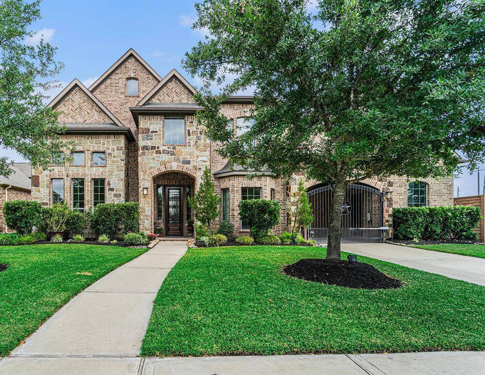 This gorgeous traditional home features 5 bedrooms, 3 full and 2 half baths, an electric gate, backyard oasis, media room, game room and much more!