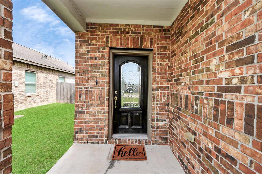This charming covered porch and bold front door set the tone for stylish comfort and warm hospitality in the heart of Missouri City.