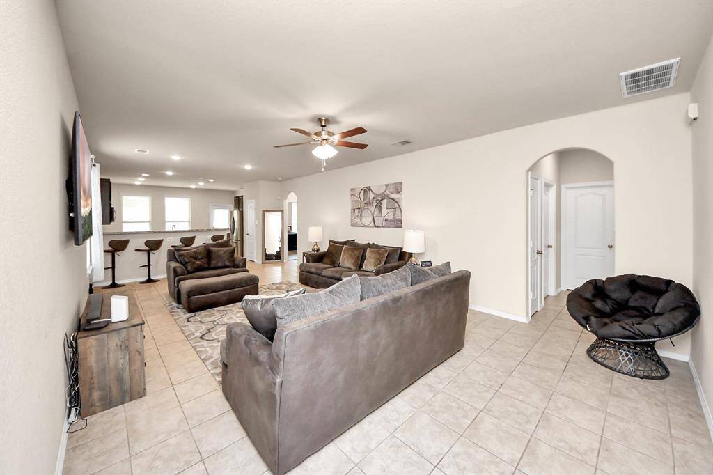 The living room offers an open layout with effortless flow, perfect for relaxing or entertaining in style.