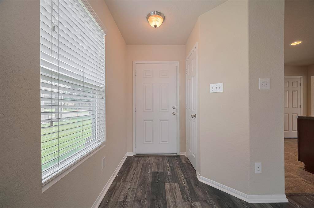 The welcoming entryway with an adjacent closet and large window, leads into the main living area.
