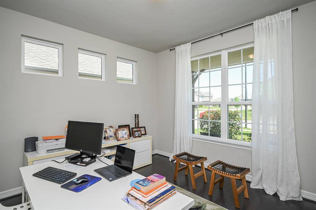 This sublime front room on the 1st level, just off the main interior hallway, offers lovely natural light (note the special trio of windows, up left.) This room can be traditionally used as a home office/study --- but can always be considered as an additional bedroom, if needed/desired.