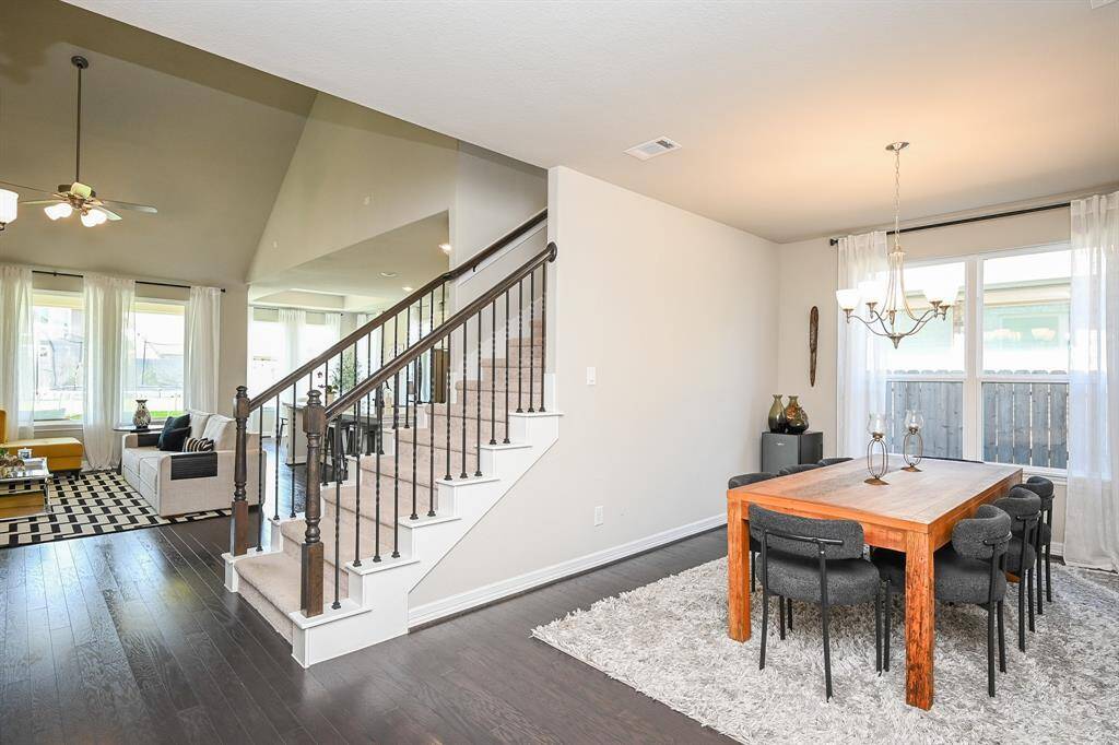 Sleek lines and common area structures define this front entry area; with direct access to the carpeted staircase , huge living area, and roomy formal dining space, right.