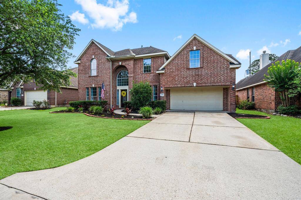 This stunning two-story brick home offers timeless curb appeal with its stately arched entryway and elegant windows. Featuring a spacious two-car tandem garage and meticulously landscaped front yard, this residence combines charm and functionality. Perfectly nestled in a quiet, well-kept neighborhood, it's the ideal setting for comfortable living and stylish entertaining.