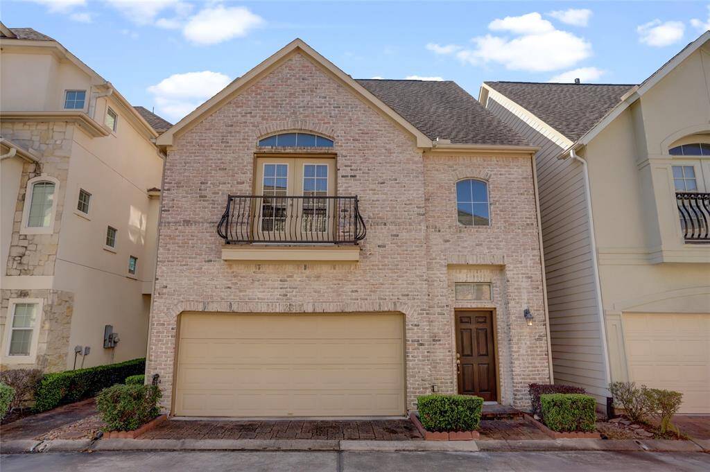 An inviting frontal view of this beautiful home, showcasing its elegant design and attached two-car garage.