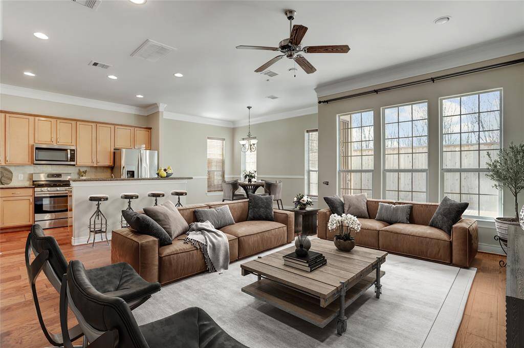 As you walk into the living room, large windows flood the space with natural light, creating a bright and inviting atmosphere. This open and airy area is perfect for entertaining or unwinding after a long day. This photo is virtually staged.