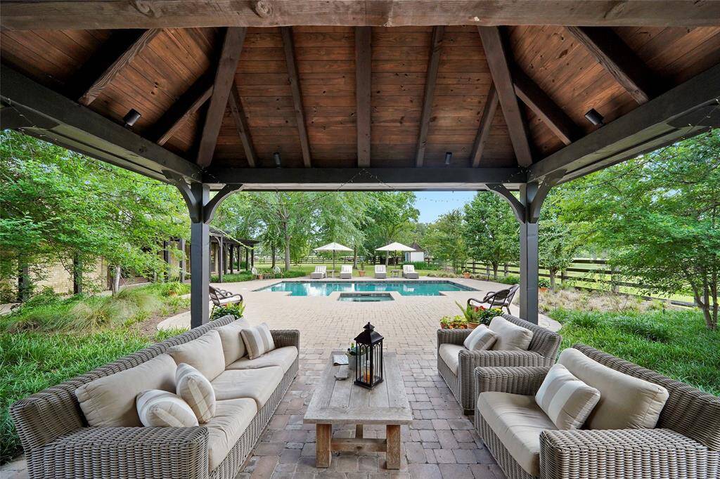 The outdoor living area overlooks a space where swimming and lounging blend effortlessly.