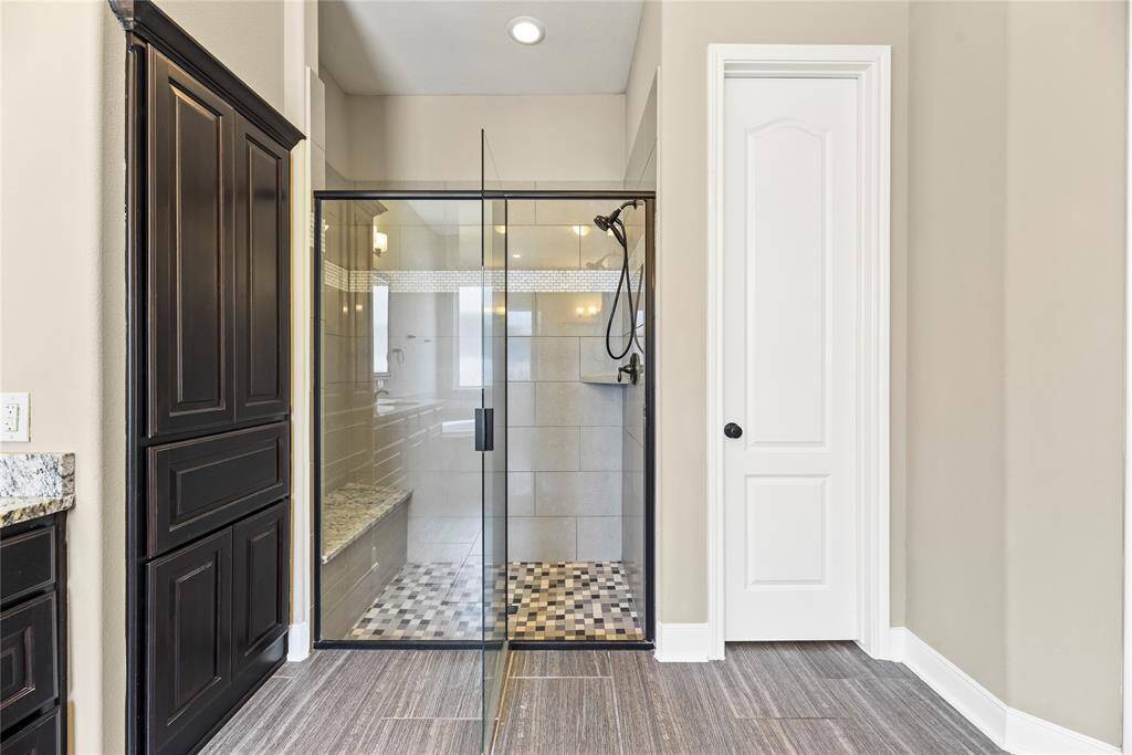 Alternate view of the primary bathroom featuring the separate glass-enclosed shower.