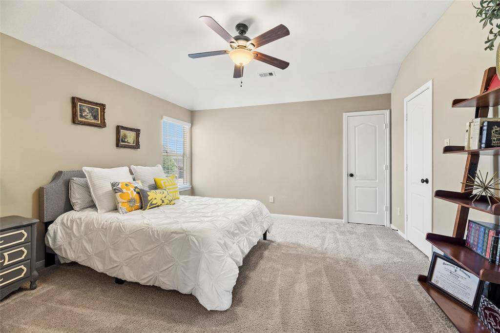 Third bedroom featuring carpet flooring and ceiling fan.