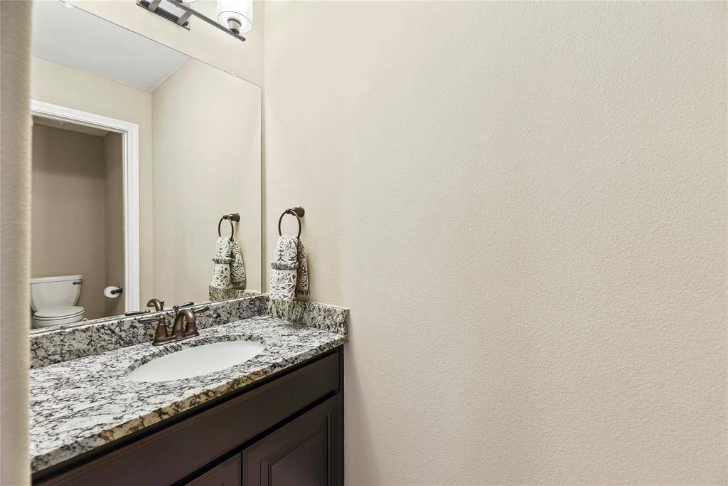 Bathroom features a granite countertop with sink and vanity.