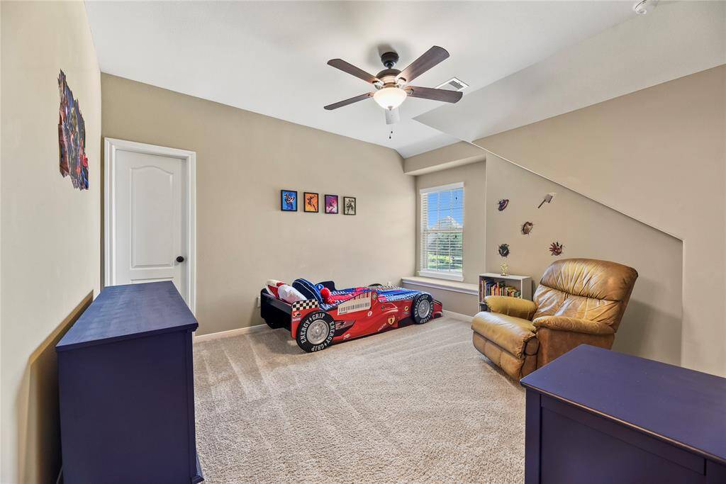 Fourth bedroom featuring a ceiling, carpet flooring, and a window.