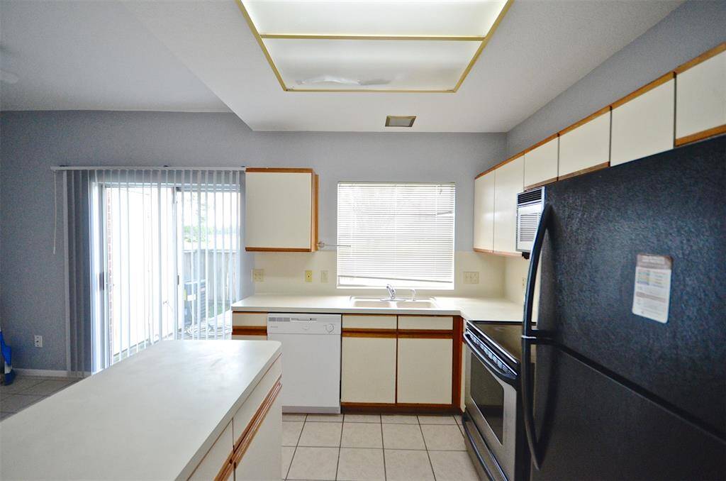 Kitchen with access to fenced back patio, green belt behind the home, no back neighbor