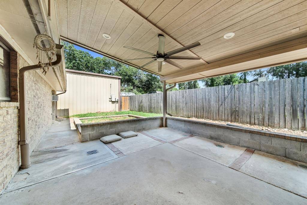 Large covered back patio ready for outdoor entertaining.