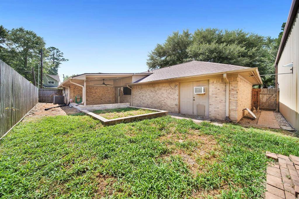 Fenced back yard with raised bed for your future garden or flowers.