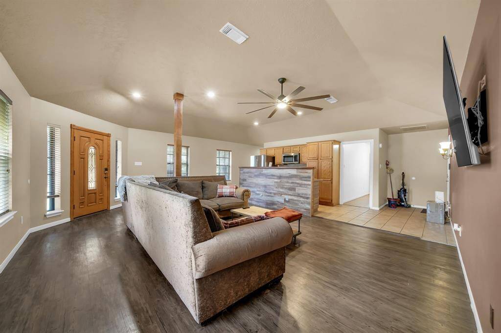 Open concept living space joins living room, dining area, and kitchen.
