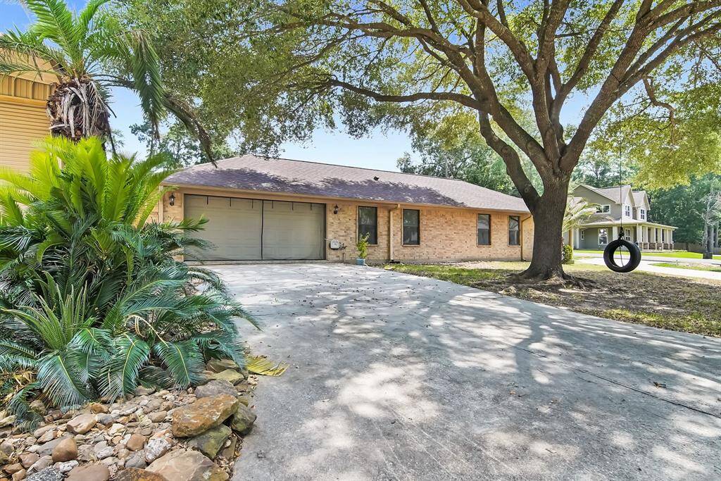 Double wide driveway with large shade tree.