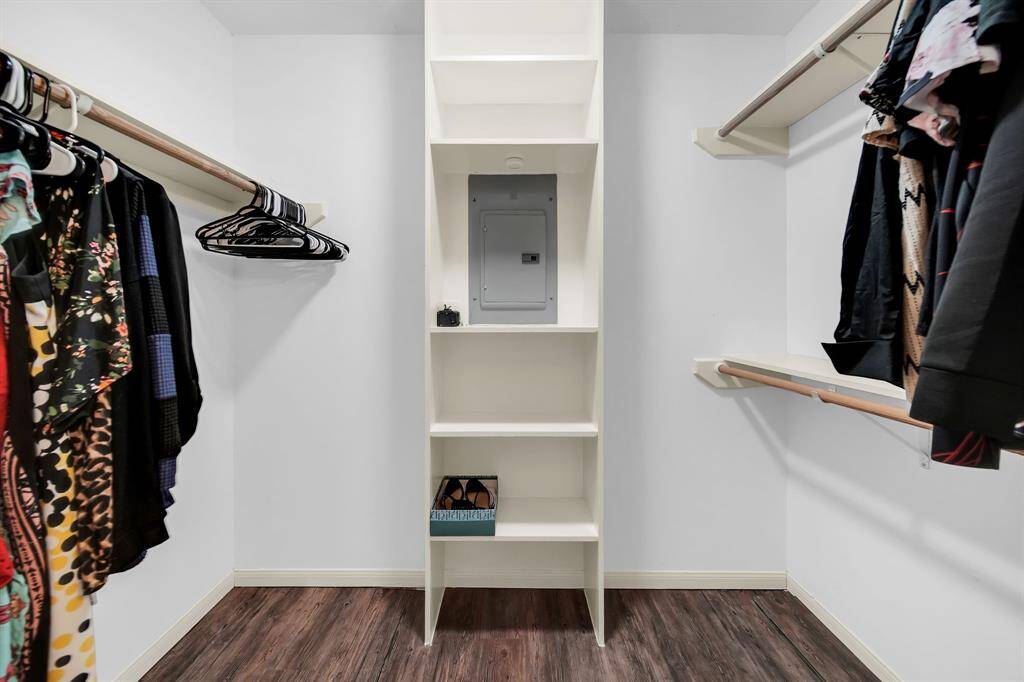 Walk in closet for primary bedroom has built in shelves.