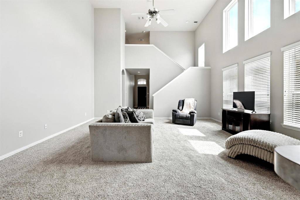 Expansive two-story living room with abundant natural light and open design.