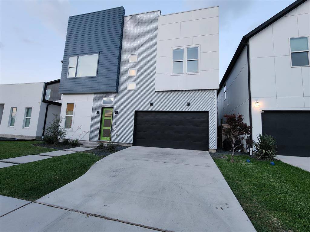 Another exterior view of 3308 Cardinal Crest Lane — Stunning modern home featuring a striking exterior with a blend of textures and colors. This spacious 4-bedroom, 3-full-bath residence includes a convenient first-level bedroom and full bath. Enjoy the attached 2-car garage and a generously sized backyard perfect for adding a pool!
