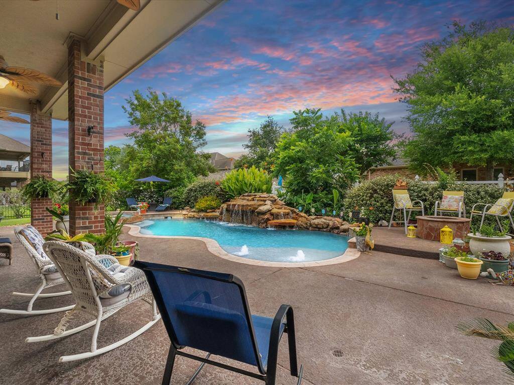 Sparkling pool and spa with expansive patio for entertaining.