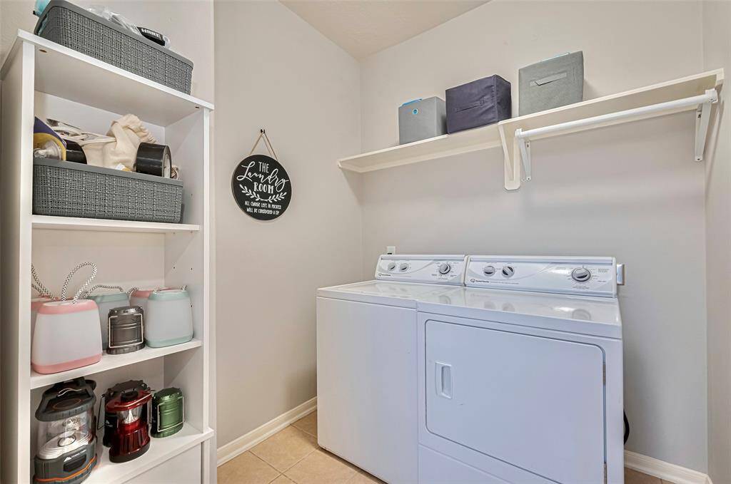 Oversized laundry room is just off the back hallway.  Added shelving to help keep your things organized.