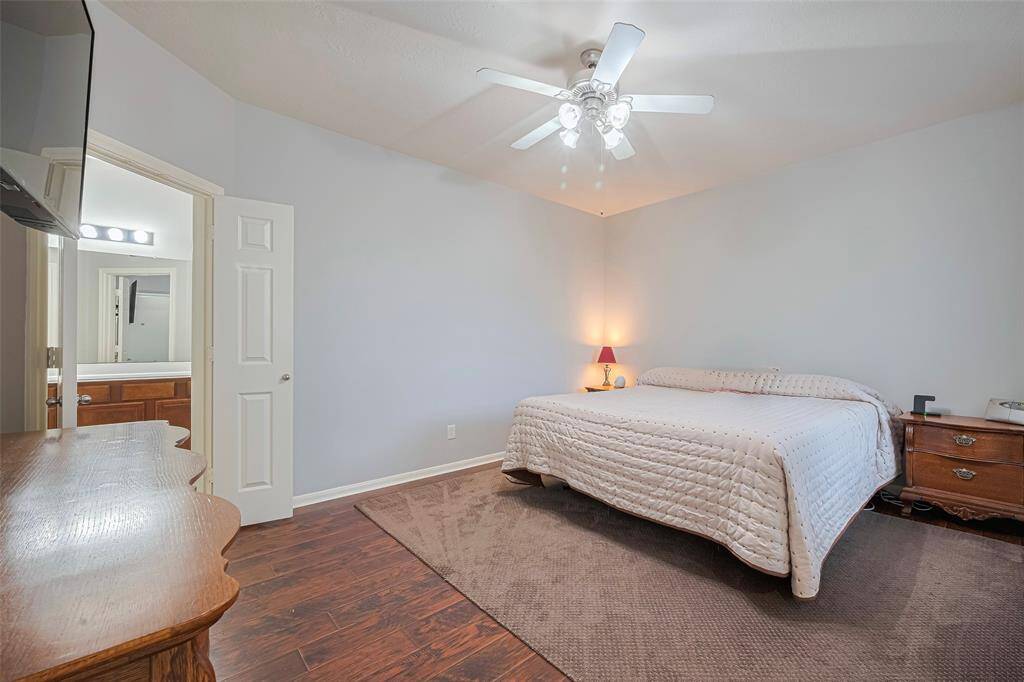 This spacious primary retreat is perfect.  Tucked n the back of the home with recessed ceilings, near the utility room and back door for garage and side yard access.