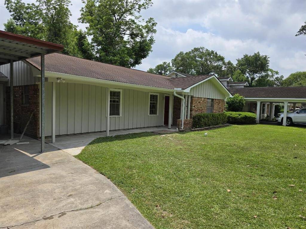 This photo showcases a charming, well-maintained home featuring a welcoming front porch, lush landscaping, and a spacious driveway. The exterior boasts a modern design with a blend of brick and siding, complemented by large windows that promise plenty of natural light inside. Perfect for buyers seeking curb appeal and a cozy neighborhood setting.