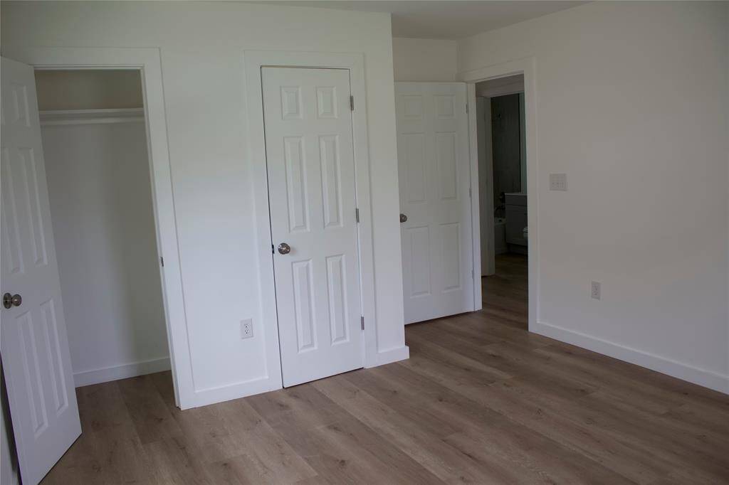 Large bedroom with view of closets