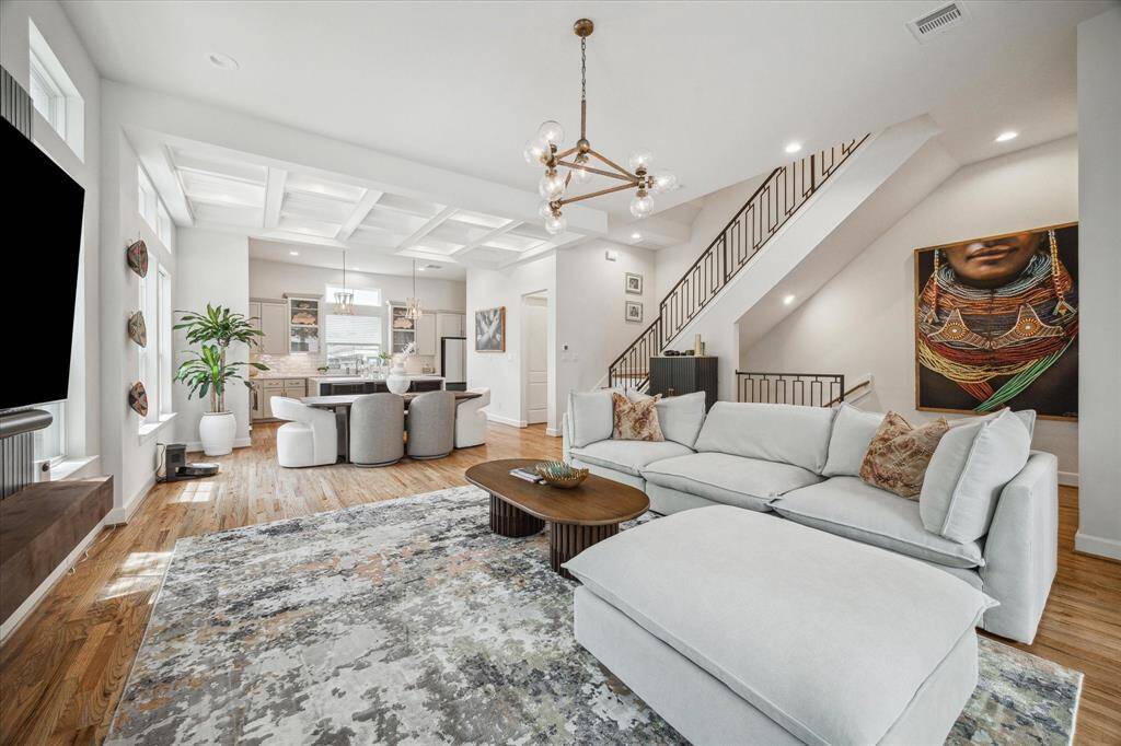 View of the second floor living space, open to dining and kitchen