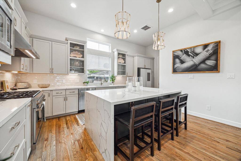 Sleek kitchen with top-of-the line appliances (including a Smart refrigerator), beverage fridge, and walk-in closet
