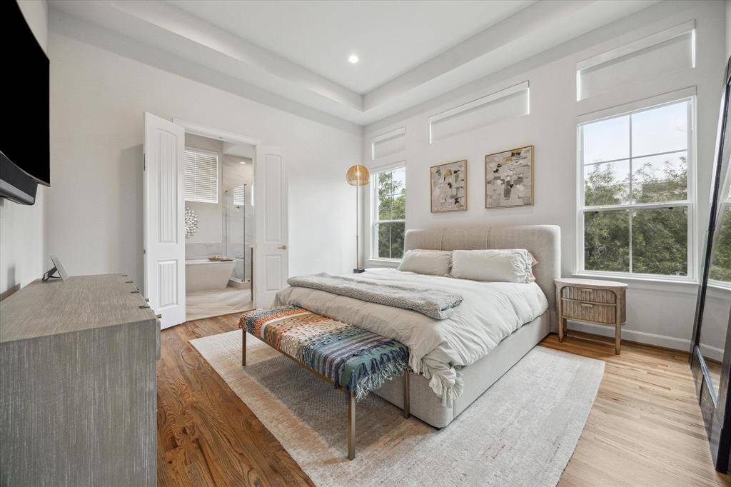 Third floor primary bed with custom electric shades, an expansive ensuite, and the biggest closet you could imagine!