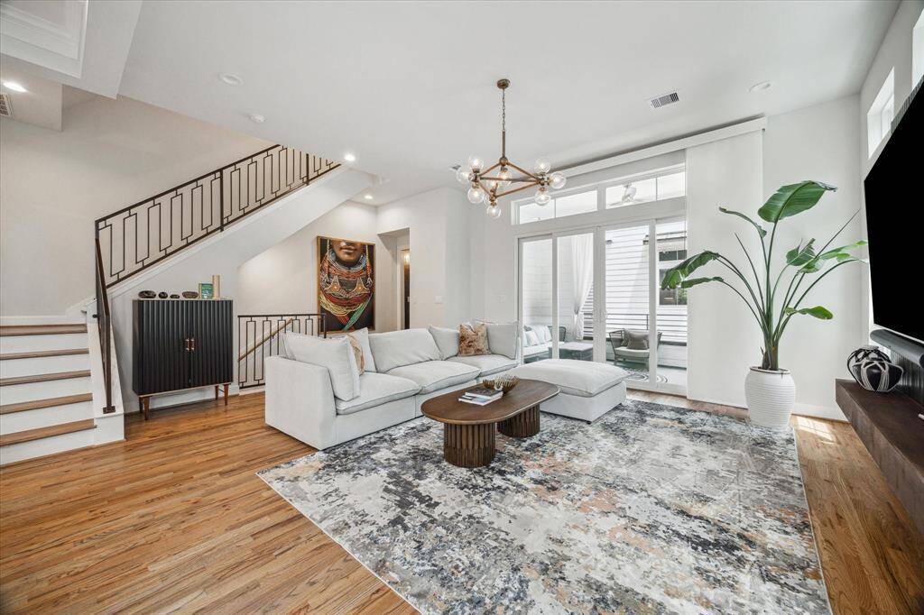 Second floor living has hardwood floors and bright windows throughout